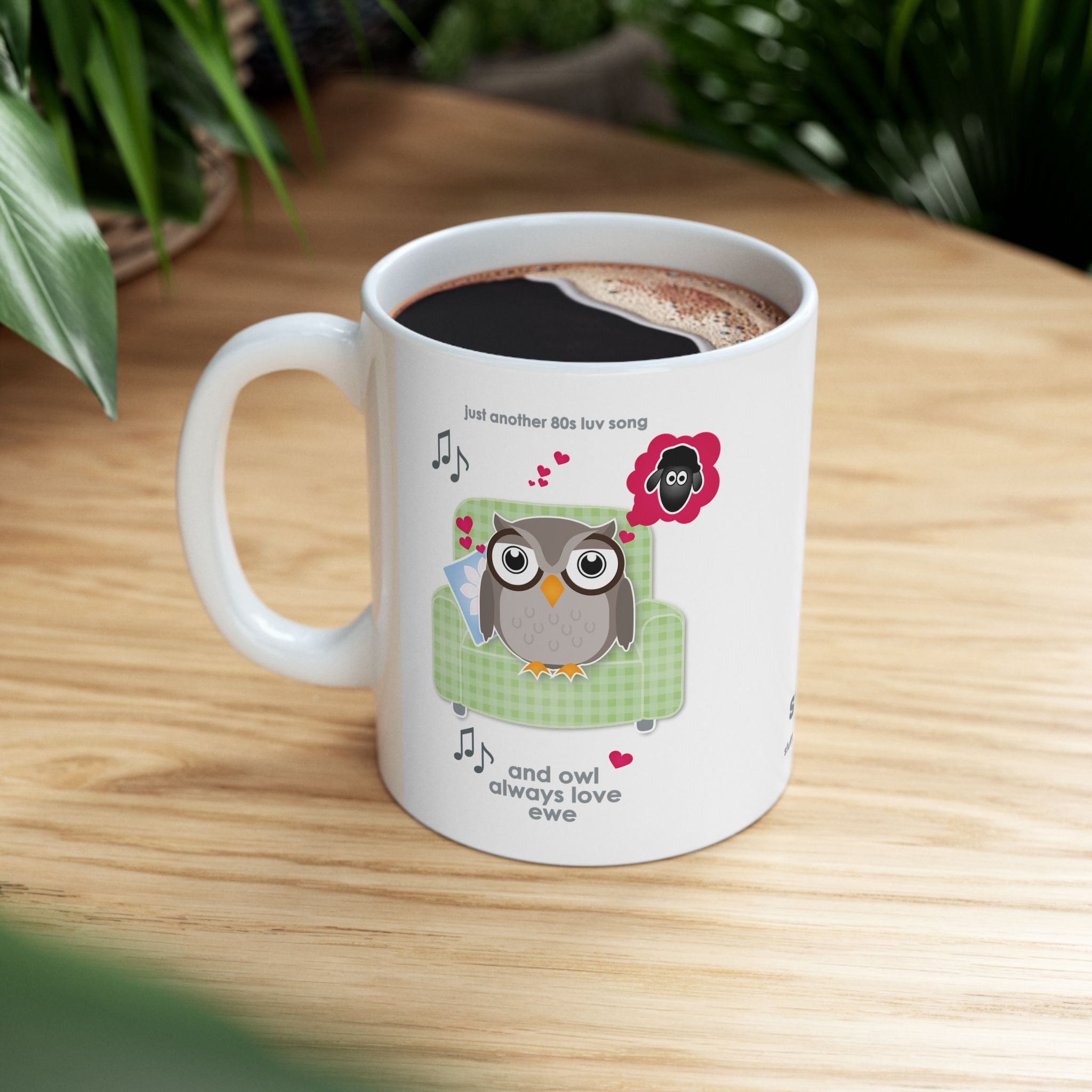 Owl Always Love Ewe Love Song Mug (11oz, 15oz) 8 White ceramic Owl Always Love Ewe Love Song Mug, printed with an owl sitting on a green chair, dreaming of a sheep. Text reads "Owl Always Love Ewe" on wooden table