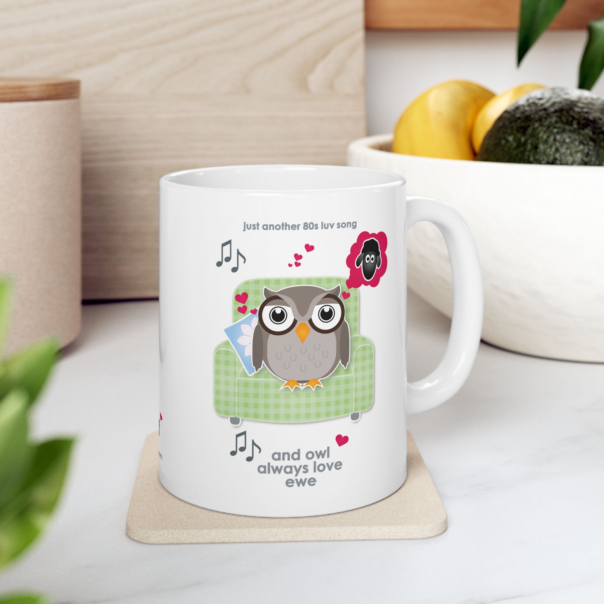 Owl Always Love Ewe Love Song Mug (11oz, 15oz) 9 White ceramic Owl Always Love Ewe Love Song Mug, printed with an owl sitting on a green chair, dreaming of a sheep. Text reads "Owl Always Love Ewe" in kitchen with fruit bowl