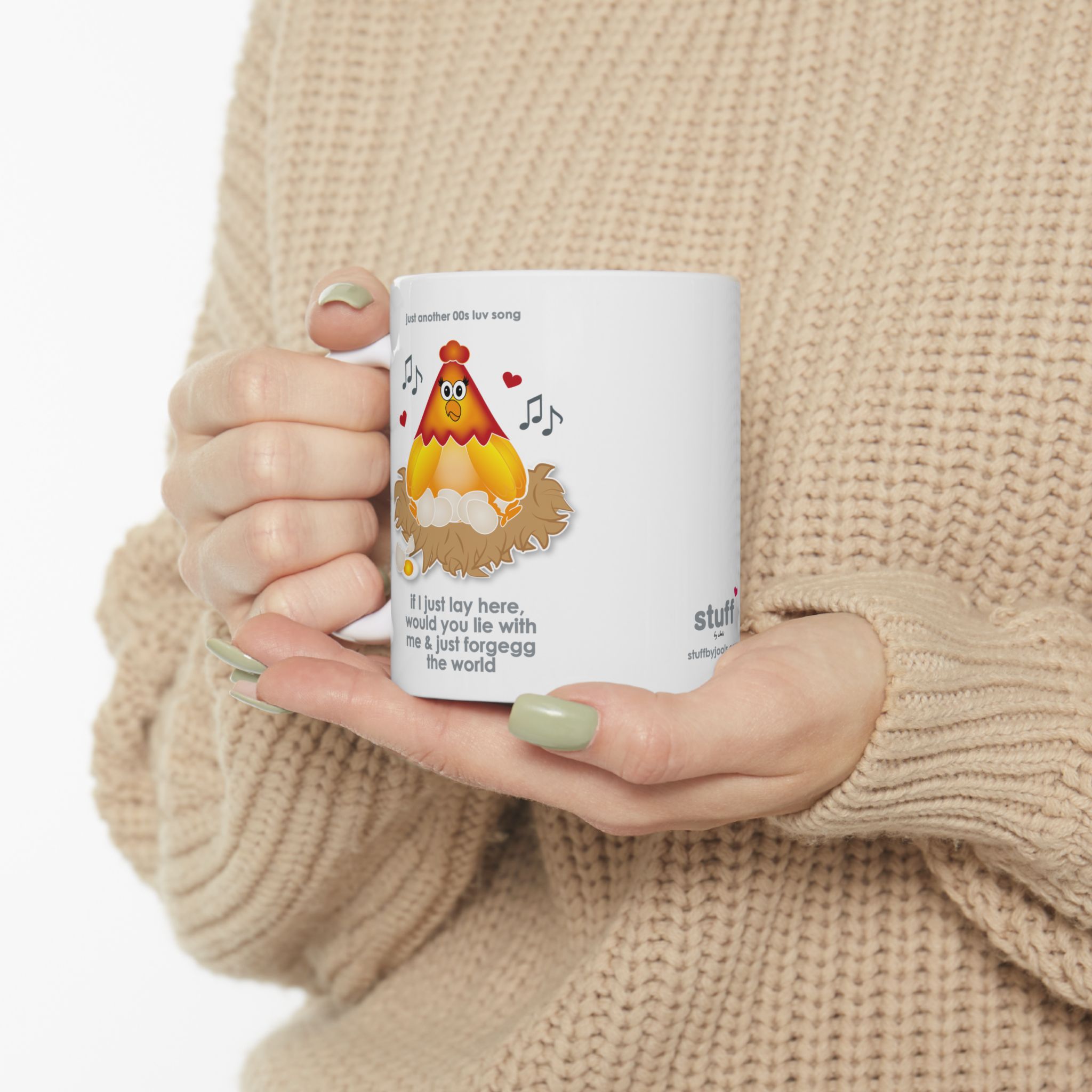 If I Lay Here Mug (11oz, 15oz) 8 White ceramic mug printed with a cartoon chicken on some eggs in a nest, text reads "if I just lay here, would you lie with me & just forgegg the world" held by woman in camel-coloured jersey