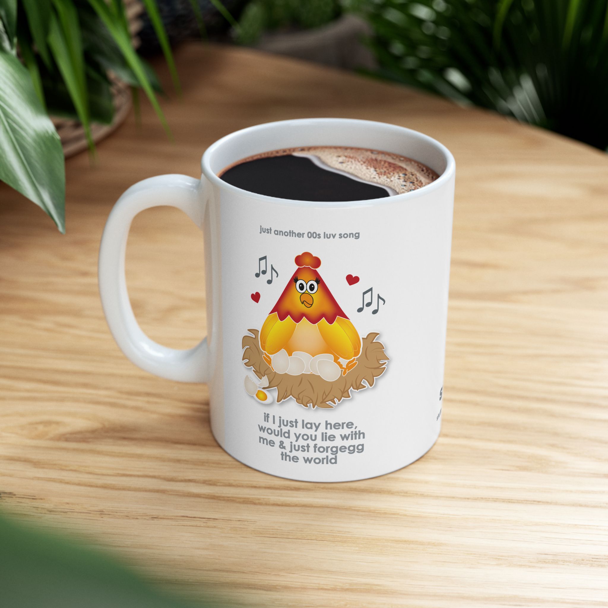 If I Lay Here Mug (11oz, 15oz) 7 White ceramic mug printed with a cartoon chicken on some eggs in a nest, text reads "if I just lay here, would you lie with me & just forgegg the world" on wooden table